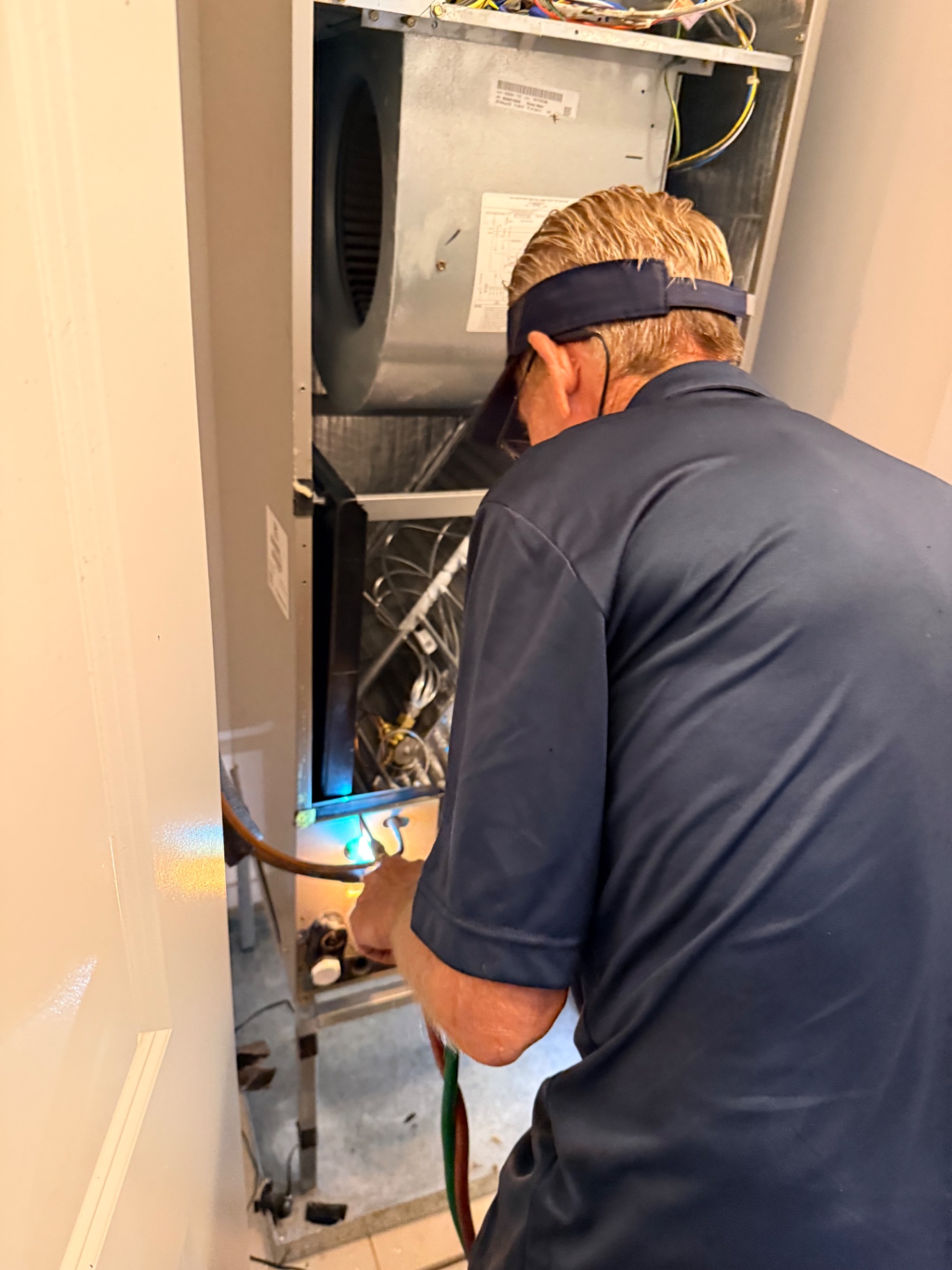 Repairing refrigerant line on vertical air handler with torch