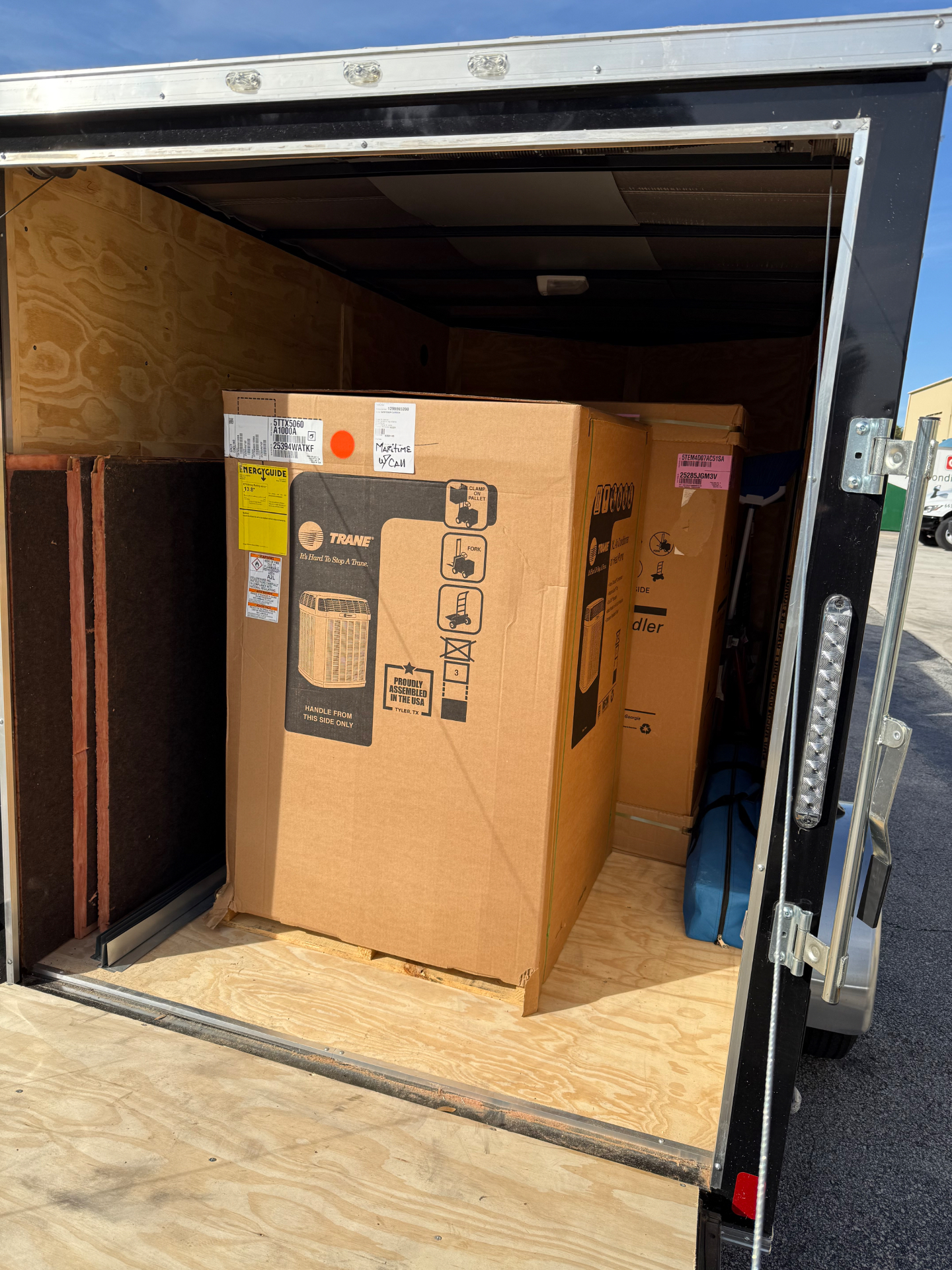 New Trane condenser and air handler loaded in Maritime Air Co. trailer for install