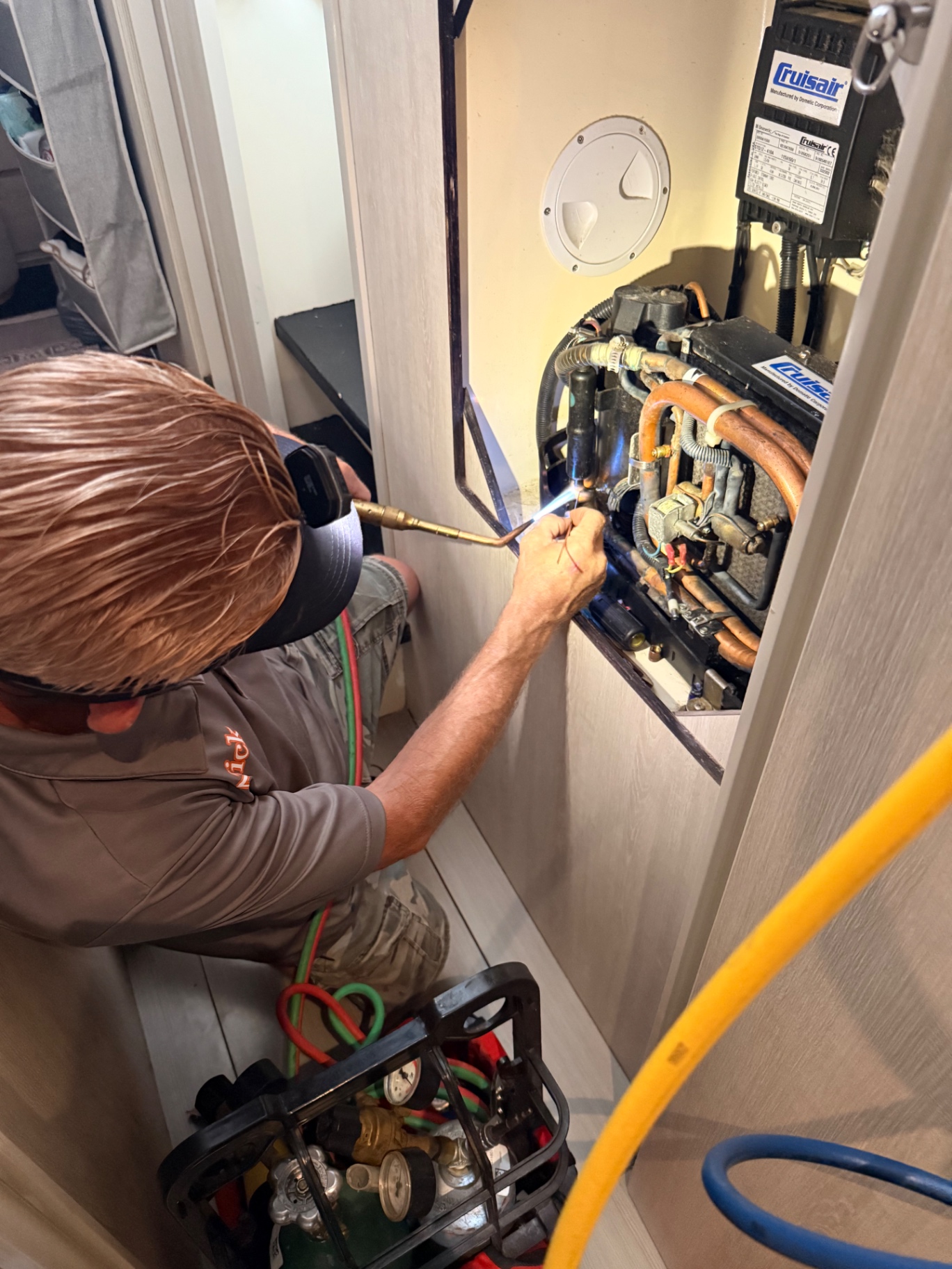 Brazing copper refrigerant lines on a Cruisair marine HVAC unit