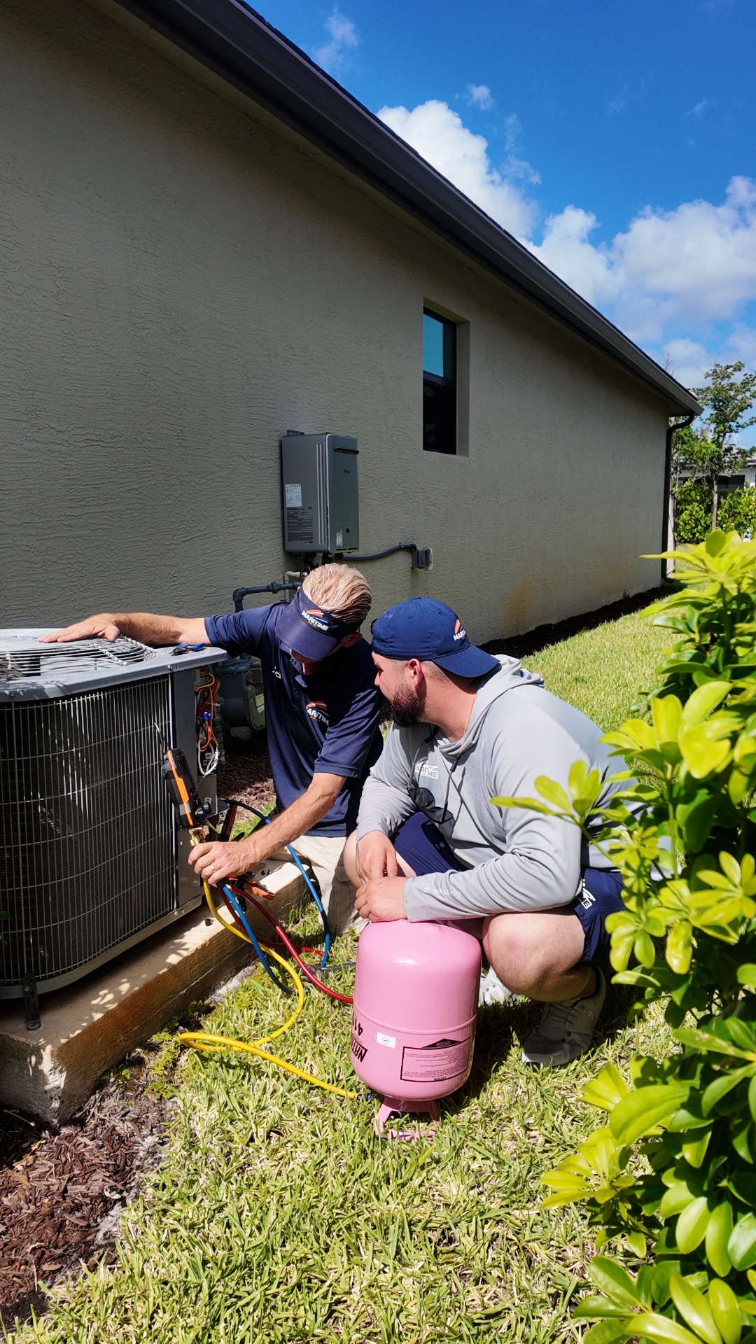 Devon and Nick servicing a residential AC unit together on a Valencia Walk call in Port St. Lucie, FL