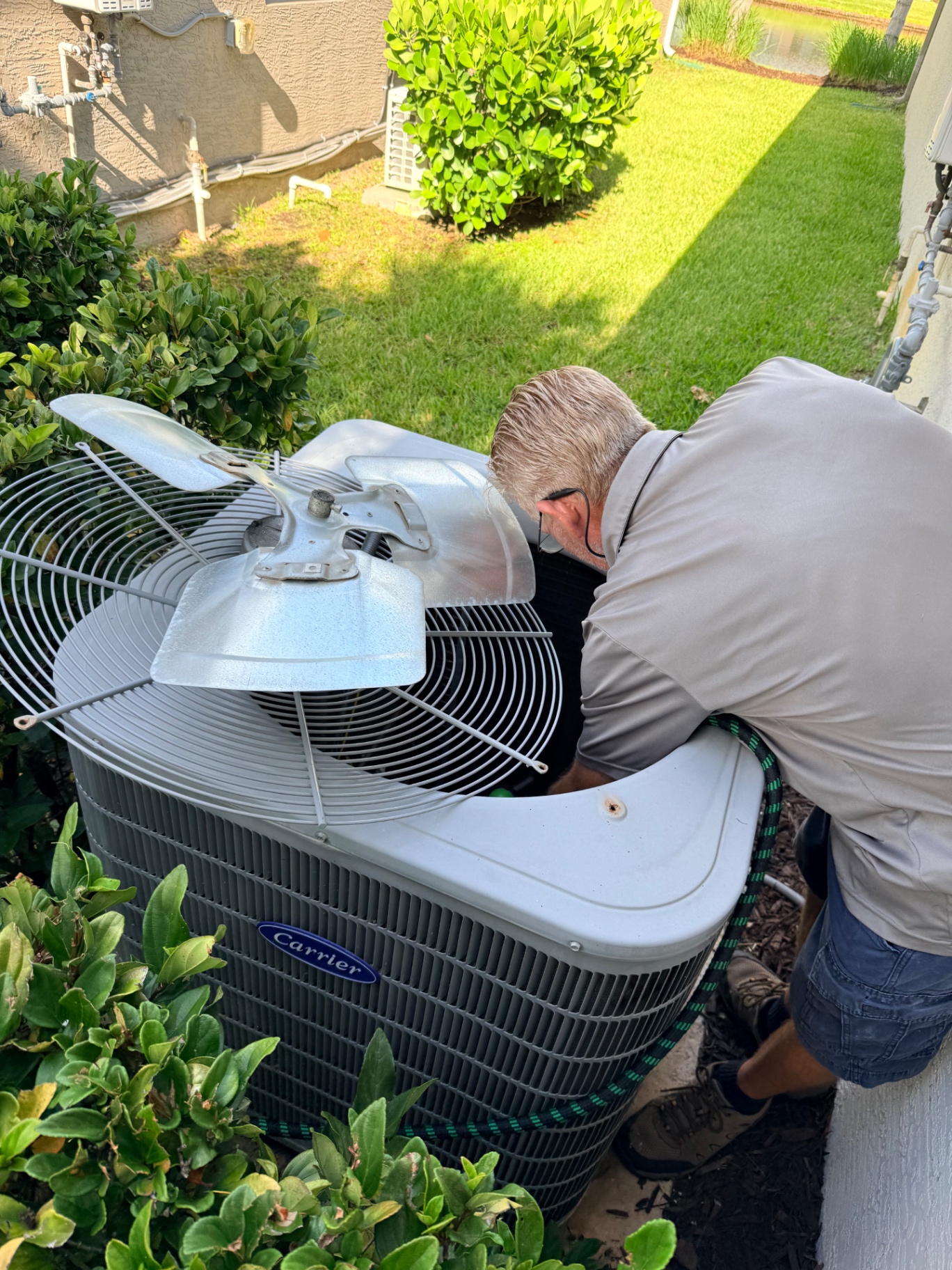 Maritime Air technician servicing Carrier condenser unit in Treasure Coast, FL