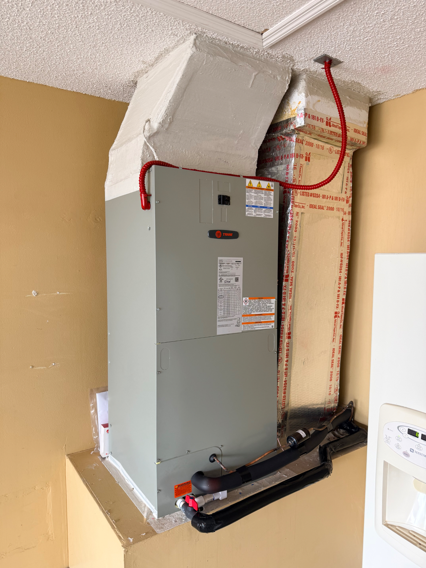 Trane A2L air handler installed in garage closet with R-454B refrigerant lines