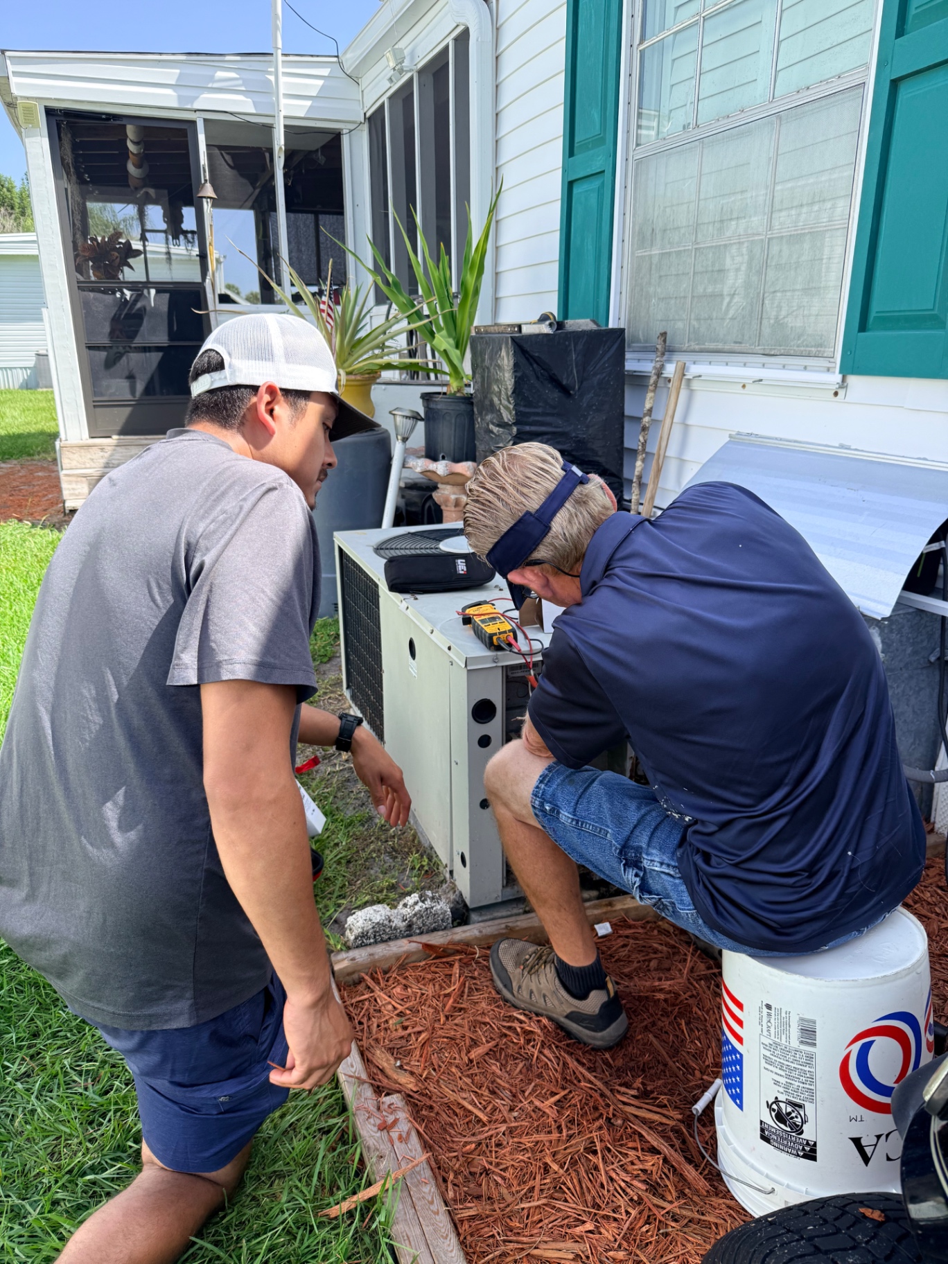Devon and Daniel field training on a residential condenser diagnostic call on the Treasure Coast