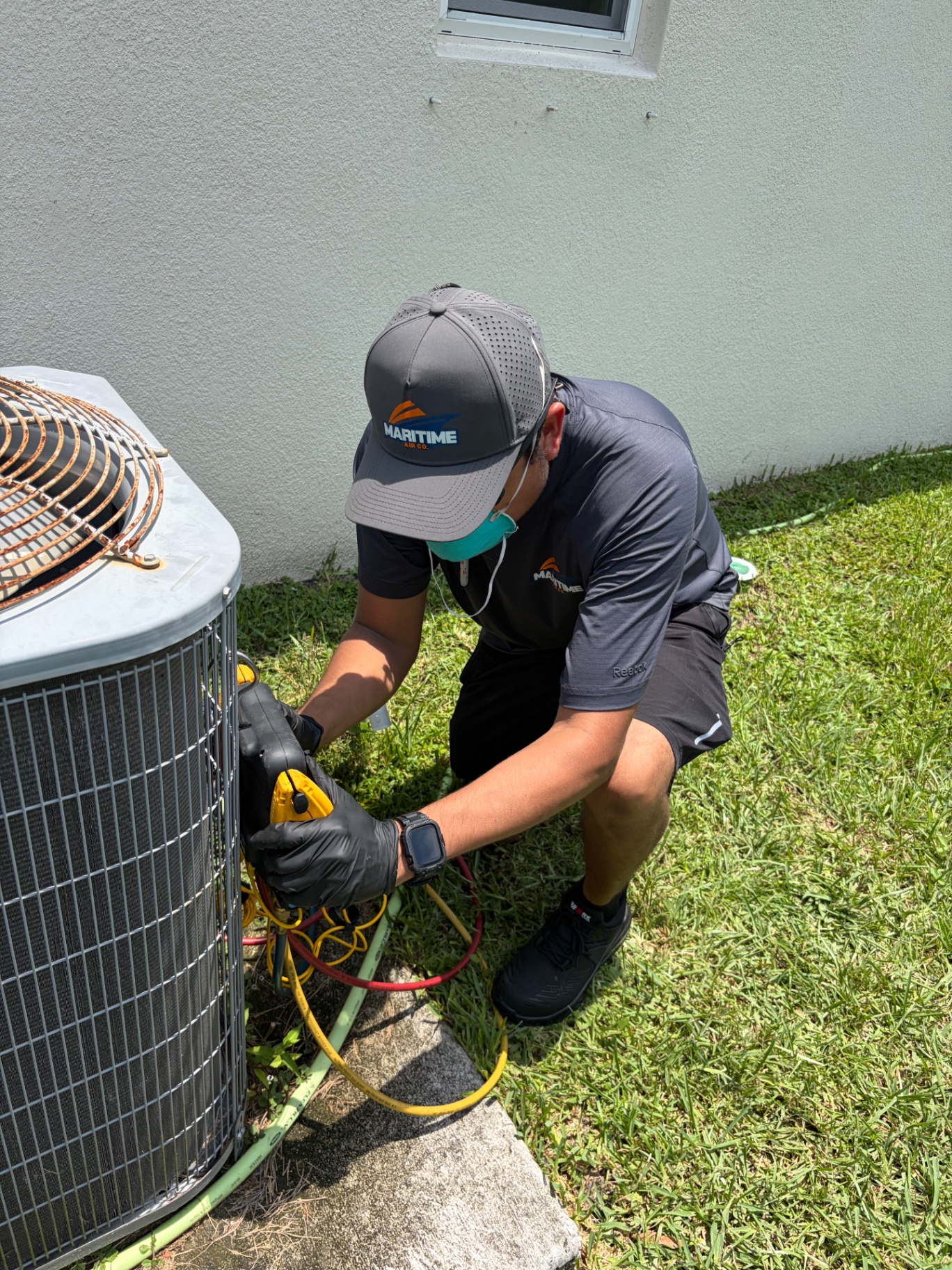 Daniel checking refrigerant pressures on a Carrier residential system in Port St. Lucie, FL
