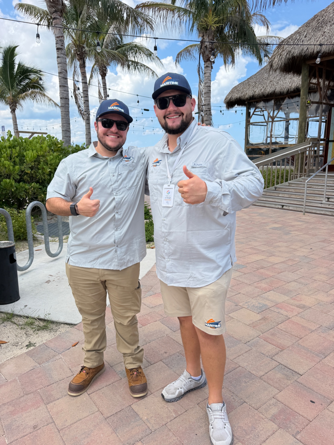 Devon and Austin of Maritime Air Co. in Maritime-branded gear on a job in Stuart, FL