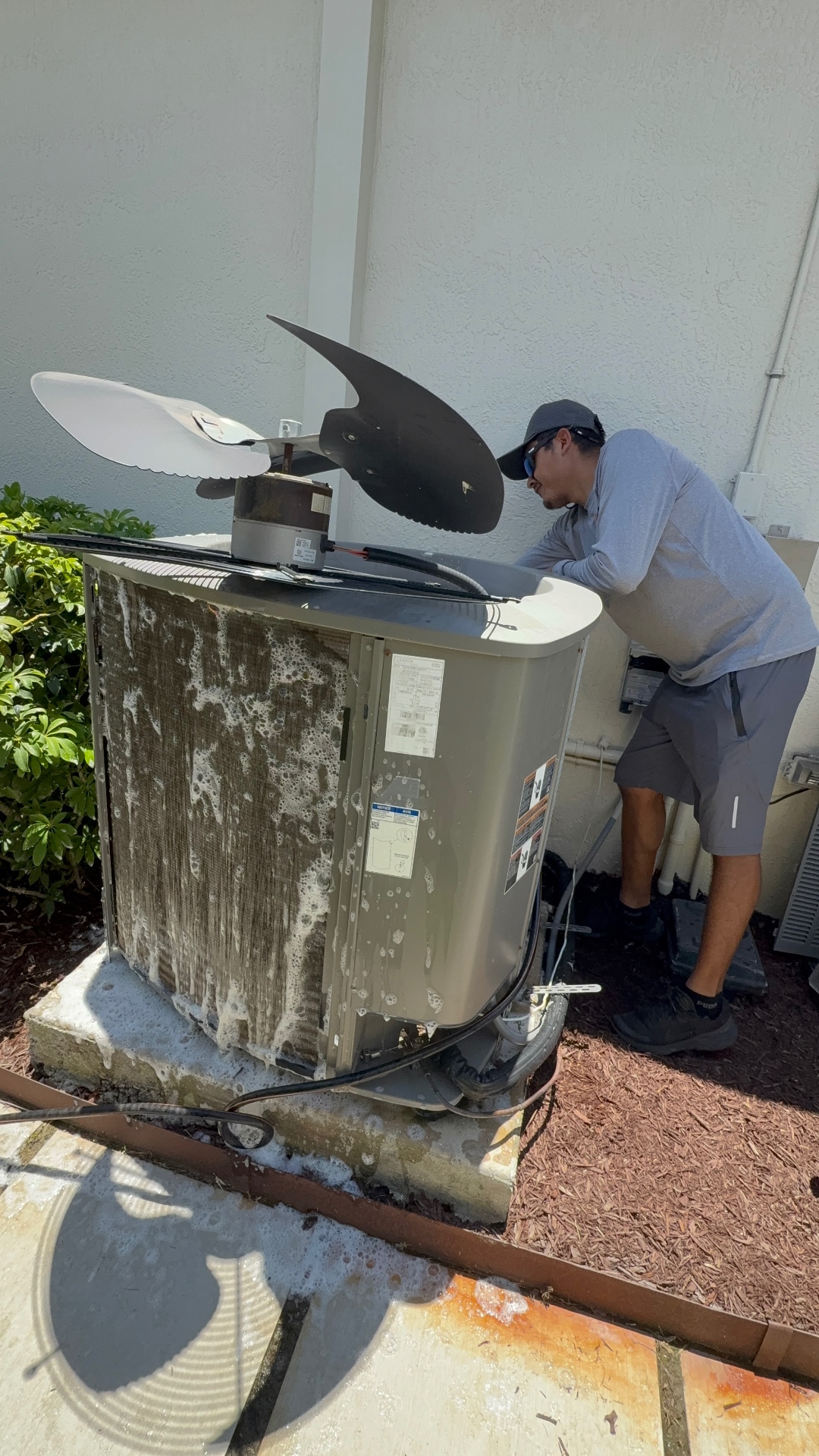Maritime Air Co. technician performing a professional coil cleaning on a coastal Lennox system in Port St. Lucie